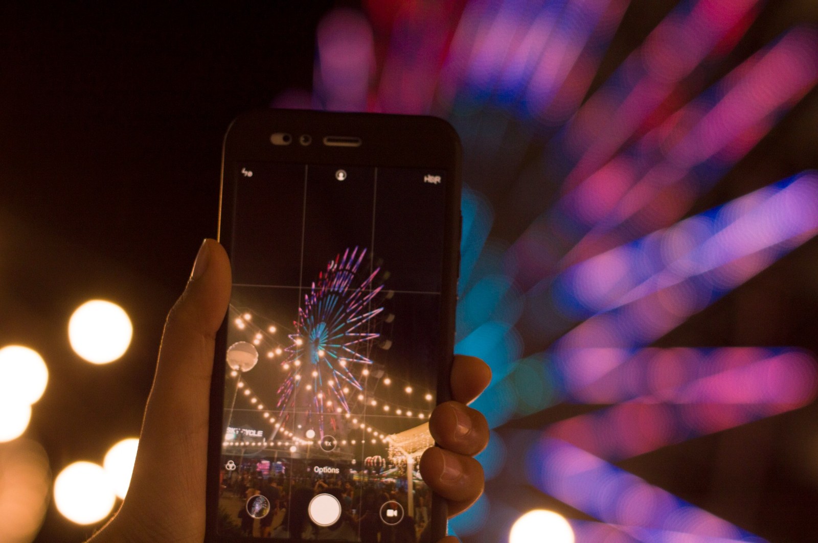 A phone capturing colorful lights at night