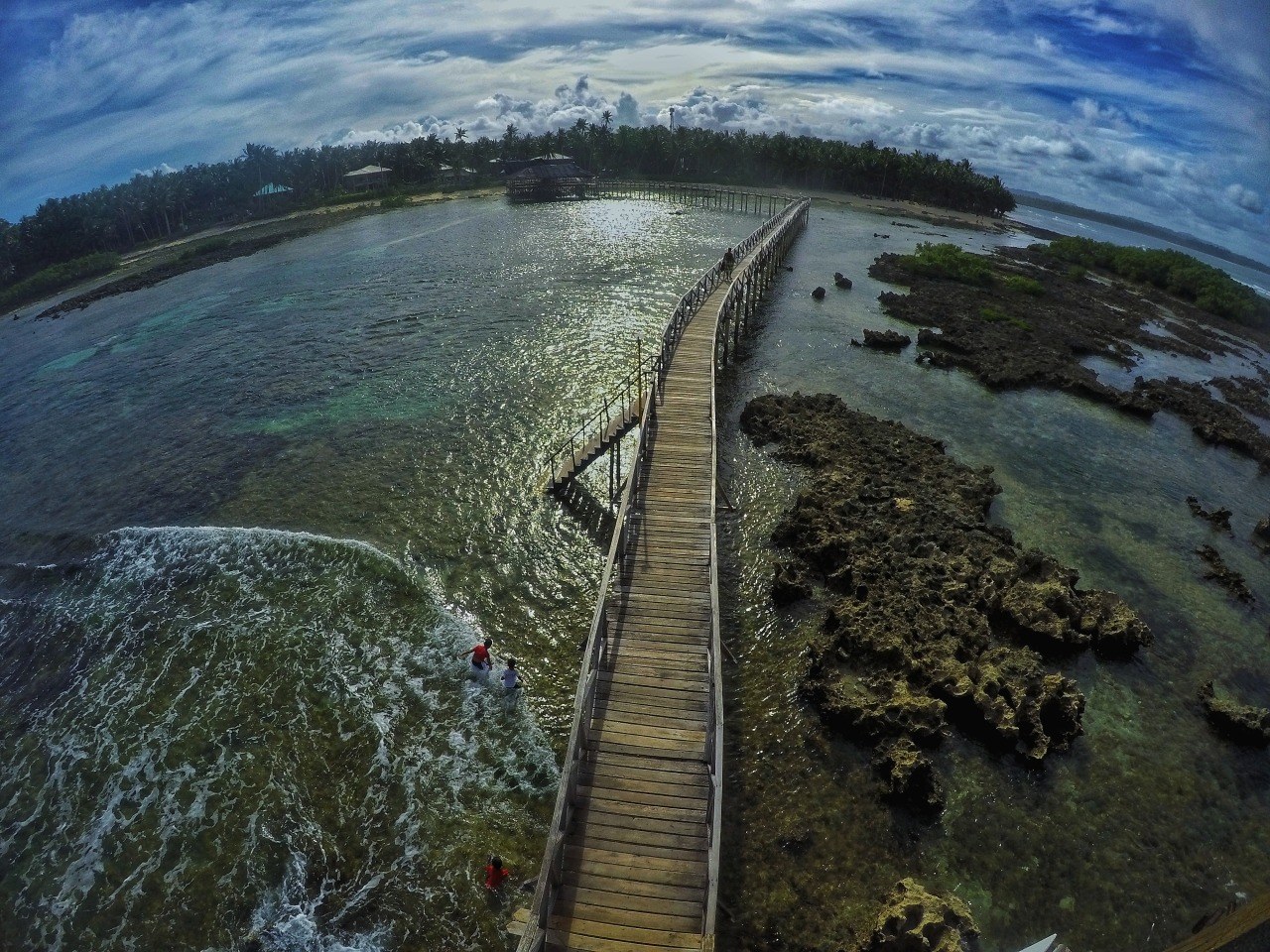 A wooden walkway stretching over clear water